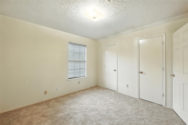 2116 S Winding Creek Dr, Grapevine, TX 76051 - unfurnished bedroom featuring light carpet and a textured ceiling