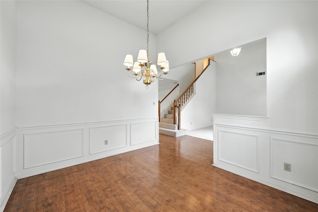 2116 S Winding Creek Dr, Grapevine, TX 76051 - unfurnished dining area featuring a decorative wall, a chandelier, stairway, vaulted ceiling, and wood finished floors
