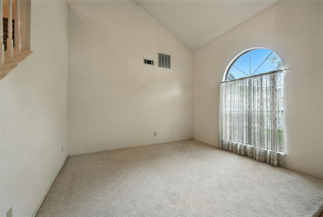 2116 S Winding Creek Dr, Grapevine, TX 76051 - carpeted spare room with vaulted ceiling