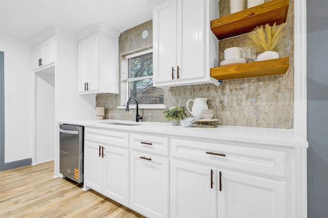 612 Circleview Dr S, Hurst, TX 76054 - kitchen with open shelves, tasteful backsplash, white cabinetry, stainless steel dishwasher, and light countertops