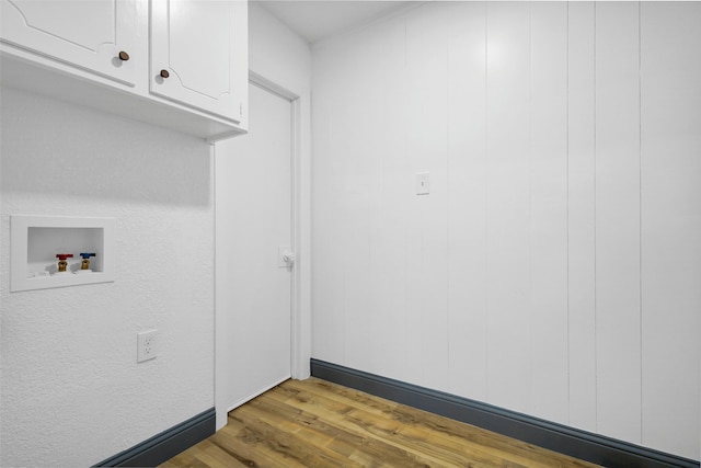 612 Circleview Dr S, Hurst, TX 76054 - laundry area featuring cabinet space, washer hookup, and wood finished floors