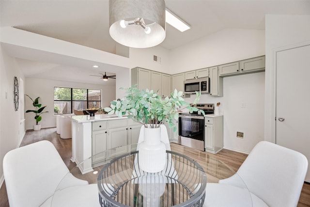 552 Kirkland Dr, Coppell, TX 75019 - dining space featuring light wood-type flooring, high vaulted ceiling, and a ceiling fan