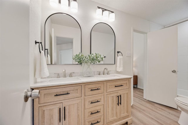 552 Kirkland Dr, Coppell, TX 75019 - full bathroom featuring double vanity and wood finished floors