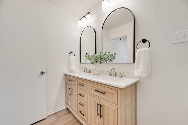 552 Kirkland Dr, Coppell, TX 75019 - full bathroom with double vanity and wood finished floors