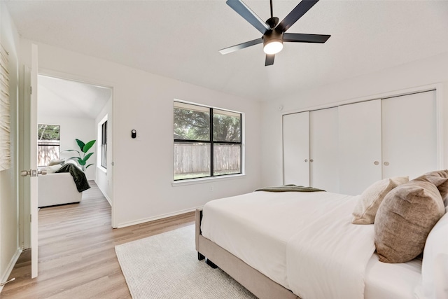 552 Kirkland Dr, Coppell, TX 75019 - bedroom featuring light wood-style flooring, multiple windows, a closet, and a ceiling fan