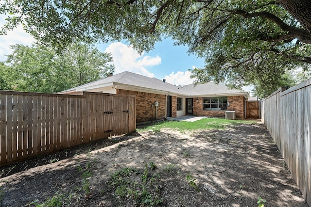 552 Kirkland Dr, Coppell, TX 75019 - back of house with a gate, a fenced backyard, brick siding, and a patio area