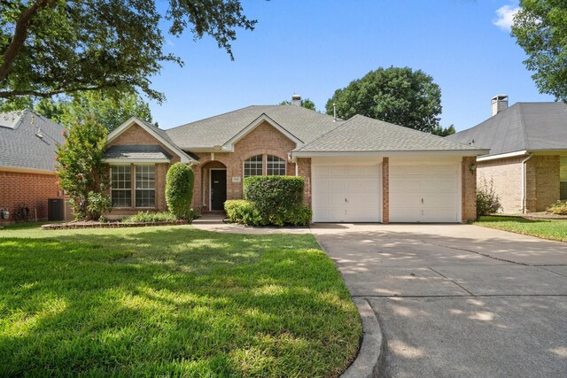 6905 Windwood Trl, Fort Worth, TX 76132 - ranch-style house with a garage, brick siding, driveway, a front yard, and roof with shingles
