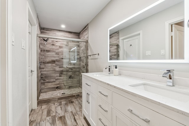 6010 Preston Creek Dr, Dallas, TX 75240 - full bath with double vanity, a shower stall, wood finished floors, and recessed lighting