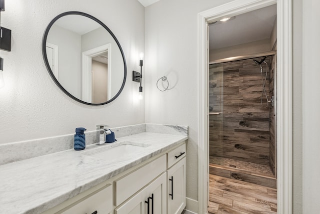 6010 Preston Creek Dr, Dallas, TX 75240 - full bath featuring vanity, a shower stall, and wood finished floors