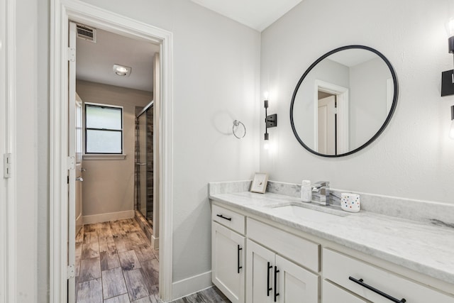 6010 Preston Creek Dr, Dallas, TX 75240 - bathroom featuring vanity, a stall shower, and wood finished floors
