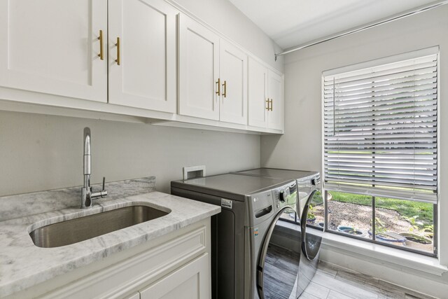 6010 Preston Creek Dr, Dallas, TX 75240 - laundry room with cabinet space, washing machine and dryer, plenty of natural light, and wood finished floors