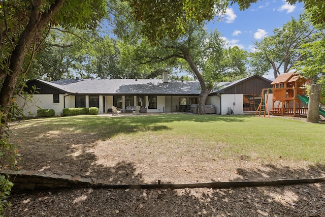 6010 Preston Creek Dr, Dallas, TX 75240 - rear view of property featuring a playground, a lawn, and a patio
