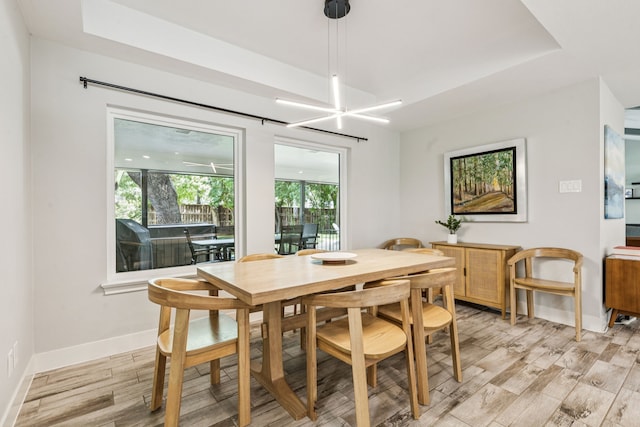 6010 Preston Creek Dr, Dallas, TX 75240 - dining room featuring a tray ceiling and light wood-type flooring