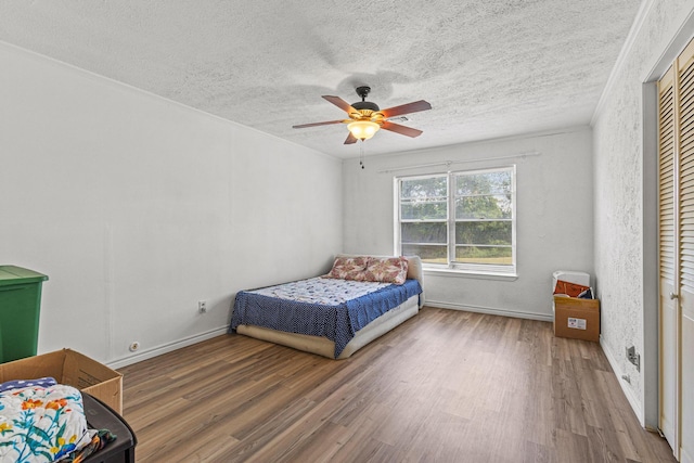 567 Celtic Rd, Howe, TX 75459 - bedroom featuring wood finished floors, a textured ceiling, and ceiling fan
