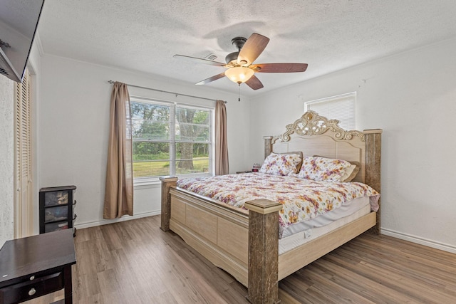 567 Celtic Rd, Howe, TX 75459 - bedroom featuring a textured ceiling, wood finished floors, ornamental molding, and ceiling fan