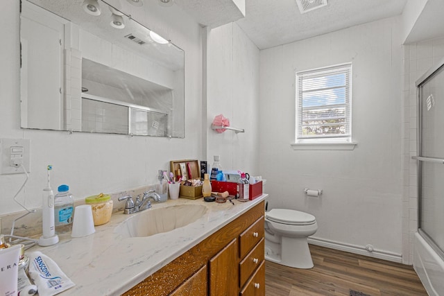 567 Celtic Rd, Howe, TX 75459 - bathroom with vanity, wood finished floors, and bath / shower combo with glass door
