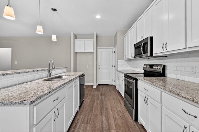 515 W Broad St, Pilot Point, TX 76258 - kitchen with appliances with stainless steel finishes, dark wood-type flooring, backsplash, white cabinetry, and pendant lighting