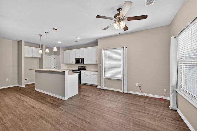 515 W Broad St, Pilot Point, TX 76258 - kitchen with appliances with stainless steel finishes, ceiling fan, dark wood-style flooring, white cabinets, and recessed lighting