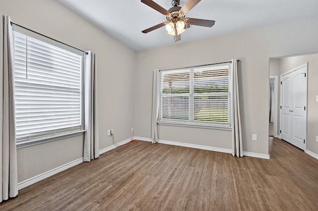 515 W Broad St, Pilot Point, TX 76258 - unfurnished bedroom with wood finished floors and ceiling fan