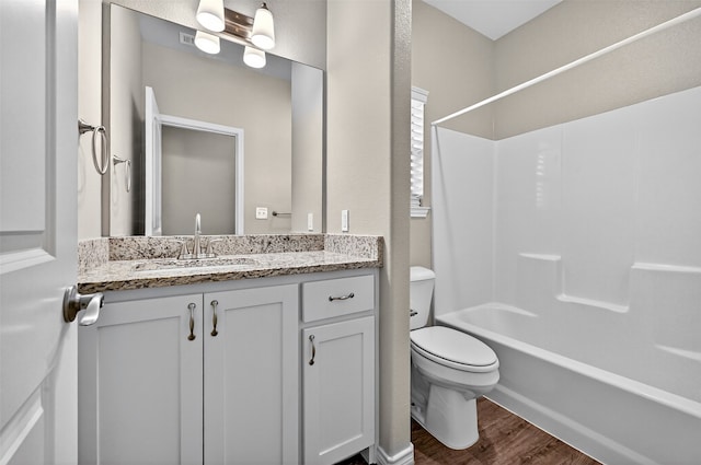 515 W Broad St, Pilot Point, TX 76258 - bathroom with wood finished floors, vanity, and shower / washtub combination