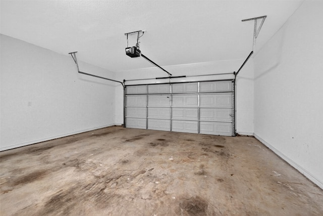 515 W Broad St, Pilot Point, TX 76258 - garage featuring a garage door opener and baseboards