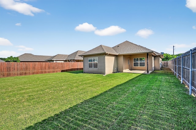 515 W Broad St, Pilot Point, TX 76258 - back of property featuring a fenced backyard, a patio, and a shingled roof