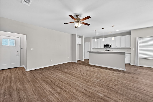 515 W Broad St, Pilot Point, TX 76258 - unfurnished living room featuring dark wood-style flooring, a ceiling fan, and recessed lighting