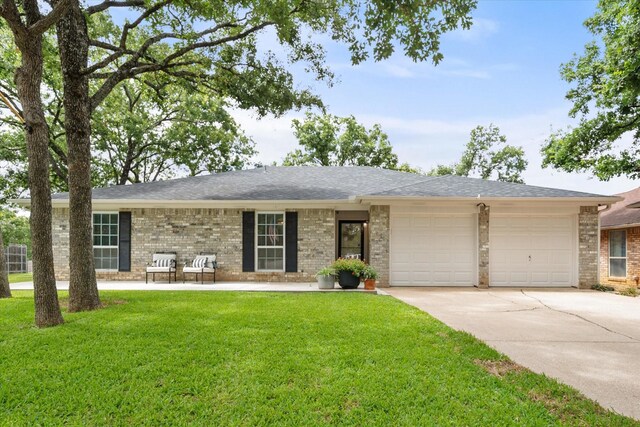 3302 Mckamy Oaks Trl, Arlington, TX 76017 - single story home with an attached garage, concrete driveway, a front lawn, and brick siding