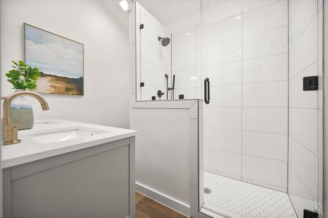 3302 Mckamy Oaks Trl, Arlington, TX 76017 - bathroom featuring a stall shower, wood finished floors, and vanity