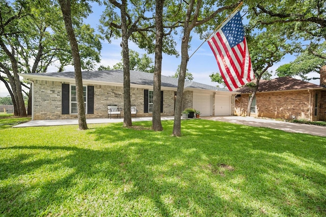 3302 Mckamy Oaks Trl, Arlington, TX 76017 - view of front facade with an attached garage, brick siding, concrete driveway, and a front lawn