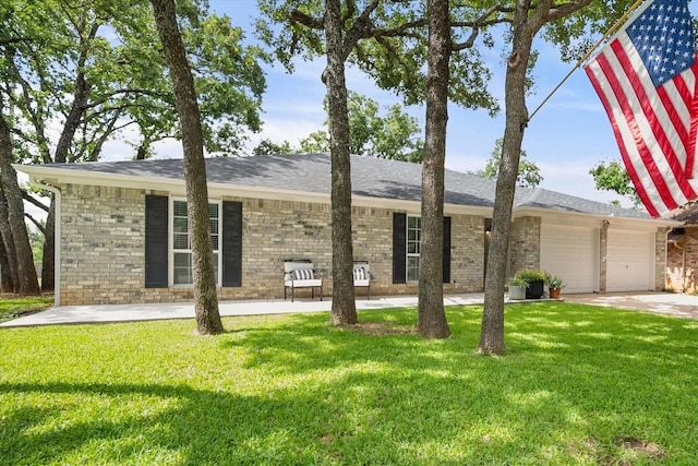 3302 Mckamy Oaks Trl, Arlington, TX 76017 - view of front of home featuring a garage, a front yard, driveway, and brick siding