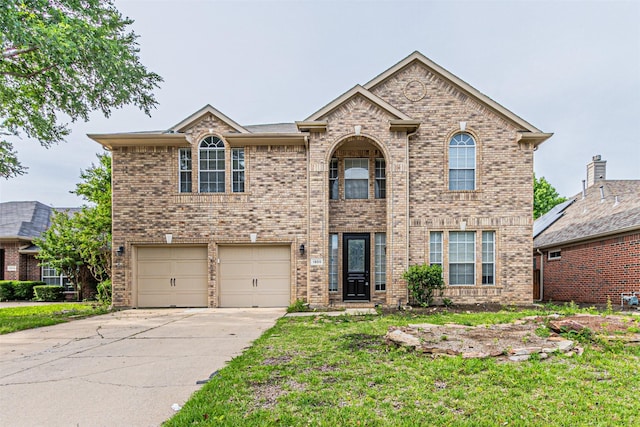 1900 Sumac Dr, Flower Mound, TX 75028 - traditional-style home featuring a garage, concrete driveway, brick siding, and a front yard