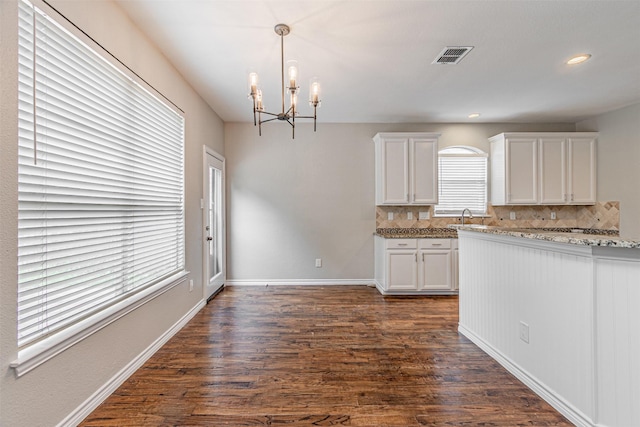 1900 Sumac Dr, Flower Mound, TX 75028 - kitchen with a chandelier, dark wood-type flooring, decorative backsplash, white cabinets, and recessed lighting