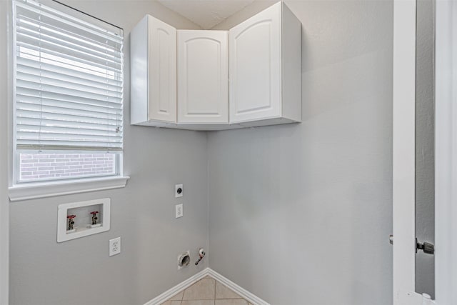 1900 Sumac Dr, Flower Mound, TX 75028 - laundry room with washer hookup, hookup for an electric dryer, tile patterned flooring, gas dryer hookup, and cabinet space