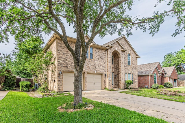 1900 Sumac Dr, Flower Mound, TX 75028 - traditional home with an attached garage, driveway, and brick siding
