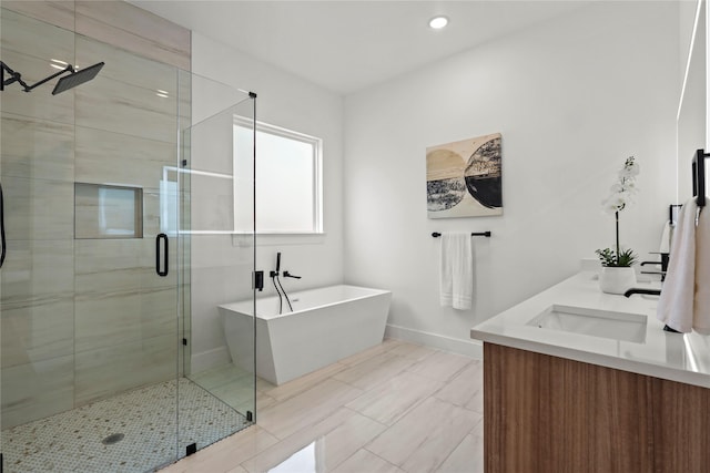 404 Cleaves St, Dallas, TX 75203 - bathroom featuring a stall shower, a freestanding bath, double vanity, and recessed lighting