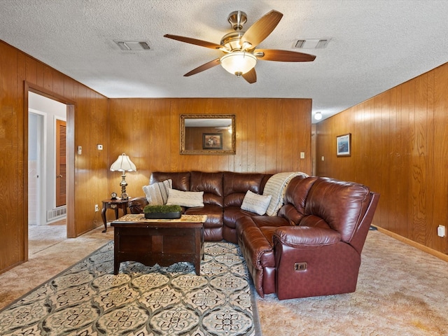 6500 Chapel Ln, Lake Worth, TX 76135 - living room with wooden walls, carpet, a ceiling fan, and a textured ceiling