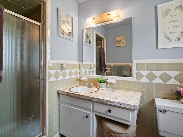 6500 Chapel Ln, Lake Worth, TX 76135 - full bathroom with tile walls, vanity, a stall shower, and a wainscoted wall
