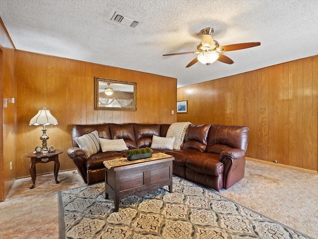 6500 Chapel Ln, Lake Worth, TX 76135 - carpeted living area featuring wood walls, ceiling fan, and a textured ceiling