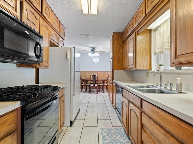 6500 Chapel Ln, Lake Worth, TX 76135 - kitchen with black appliances, a ceiling fan, light countertops, a textured ceiling, and brown cabinetry