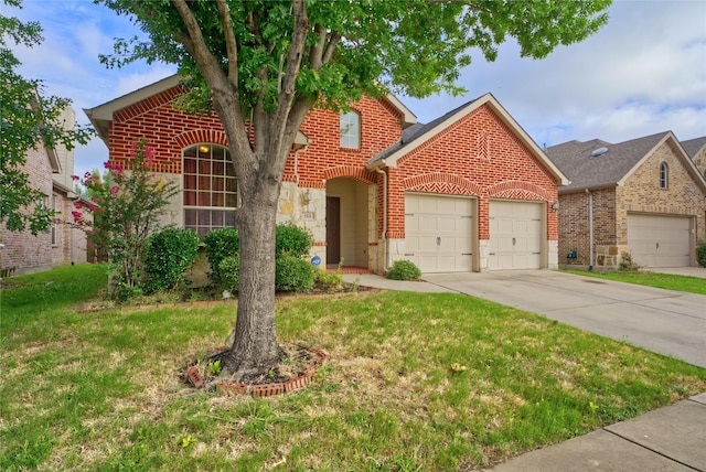 508 Hummingbird Dr, Little Elm, TX 75068 - traditional-style house with brick siding, a garage, concrete driveway, a front yard, and stone siding