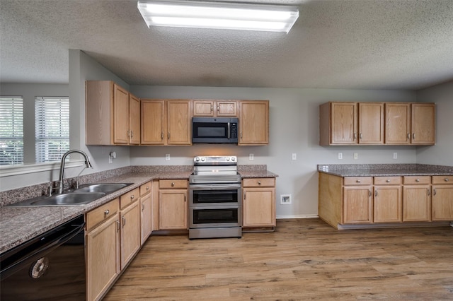 1640 Fieldstone Dr, Little Elm, TX 75068 - kitchen featuring stainless steel appliances, a textured ceiling, light wood finished floors, and light brown cabinets