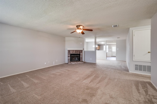 1640 Fieldstone Dr, Little Elm, TX 75068 - unfurnished living room with ceiling fan, carpet floors, a fireplace, and a textured ceiling