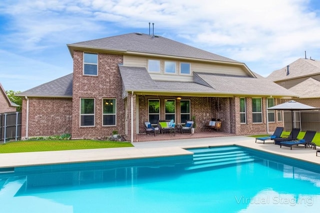 10014 Edgeway Cir, Rowlett, TX 75089 - back of property with a patio area, brick siding, and a shingled roof