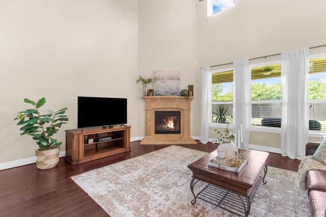 10014 Edgeway Cir, Rowlett, TX 75089 - living area with dark wood finished floors, a lit fireplace, and a towering ceiling