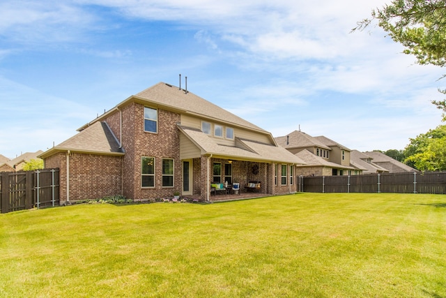 10014 Edgeway Cir, Rowlett, TX 75089 - rear view of house with brick siding, a fenced backyard, a patio area, and roof with shingles