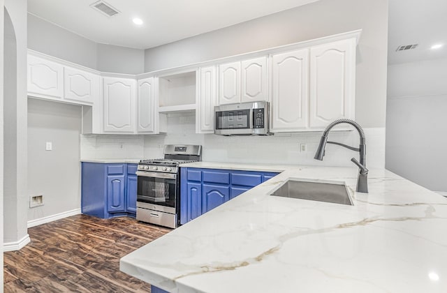 3674 Crowberry Way, Fort Worth, TX 76040 - kitchen with stainless steel appliances, blue cabinets, white cabinets, light stone countertops, and recessed lighting