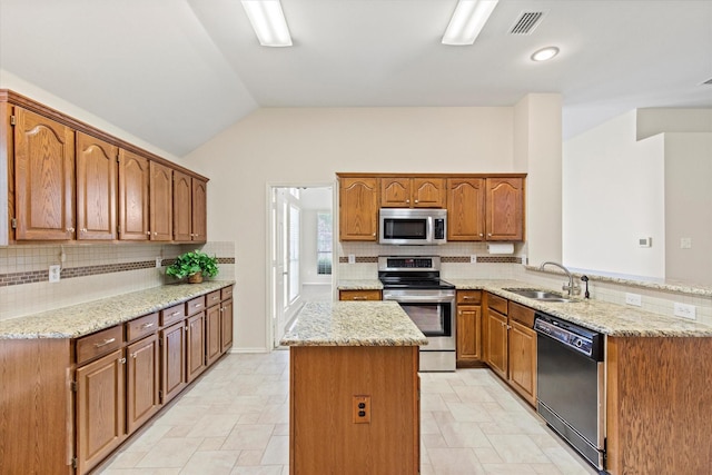 4315 Sarasota Ln, Mckinney, TX 75070 - kitchen featuring stainless steel appliances, a center island, backsplash, a peninsula, and lofted ceiling