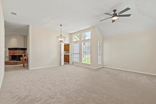 4315 Sarasota Ln, Mckinney, TX 75070 - unfurnished living room featuring light carpet, a brick fireplace, vaulted ceiling, ceiling fan, and a chandelier