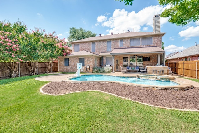 2701 Timberhill Dr, Flower Mound, TX 75028 - back of house with a fenced backyard, a patio area, a chimney, a pool with connected hot tub, and brick siding